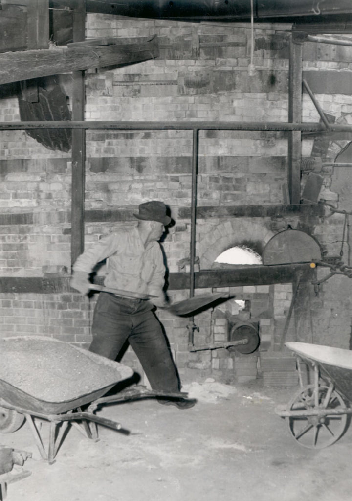 Archie Bray putting soda in beehive kiln